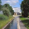 Huddersfield Narrow Canal: site of former Sellers Lock 3E looking east to new Kirklees College building by Malcolm Hinchliffe – 15 July 2012